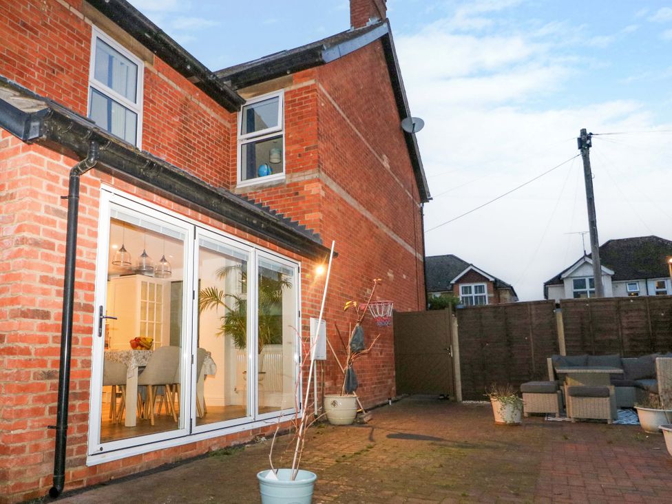 A garden with brick walls and patio furniture at 213 Gordon Avenue in Camberley