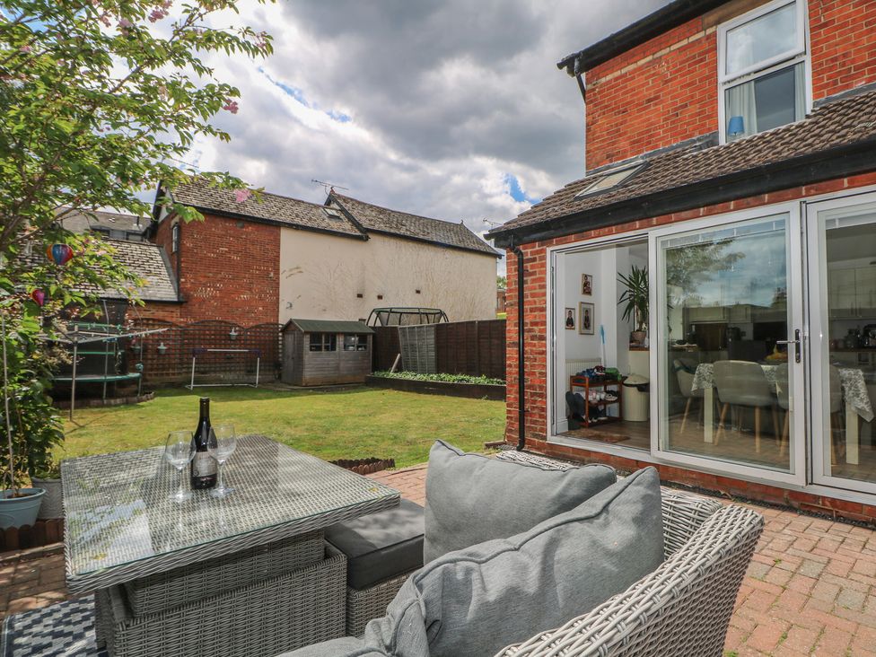 A garden with a table and chairs at Gordon Avenue in Camberley