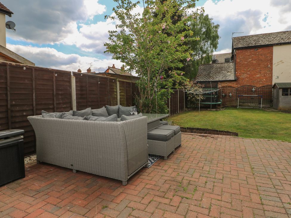A garden with a sofa and grass area at Gordon Avenue in Camberley