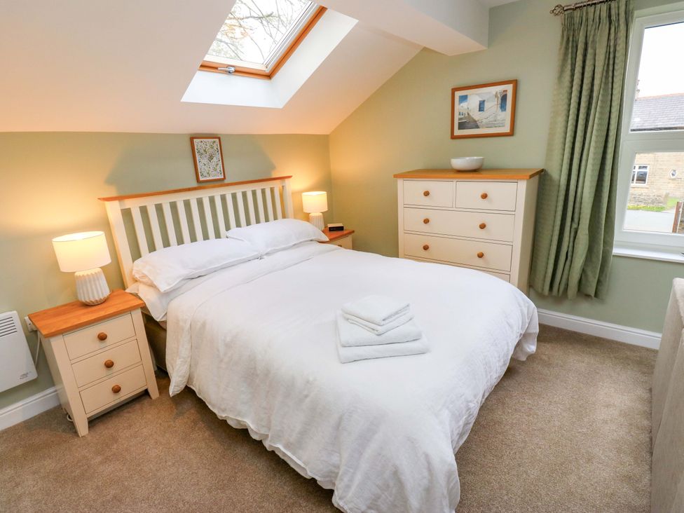 A bedroom with a bed and dresser at Chapel House Annex in Scholes