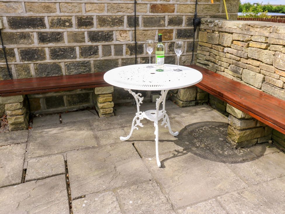 A table with glasses and a bottle at Chapel House Annex in Scholes