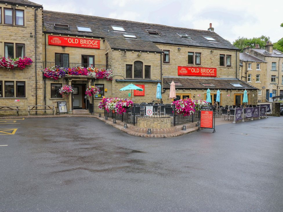 A building with flowers and outdoor seating at The Old Bridge in Scholes
