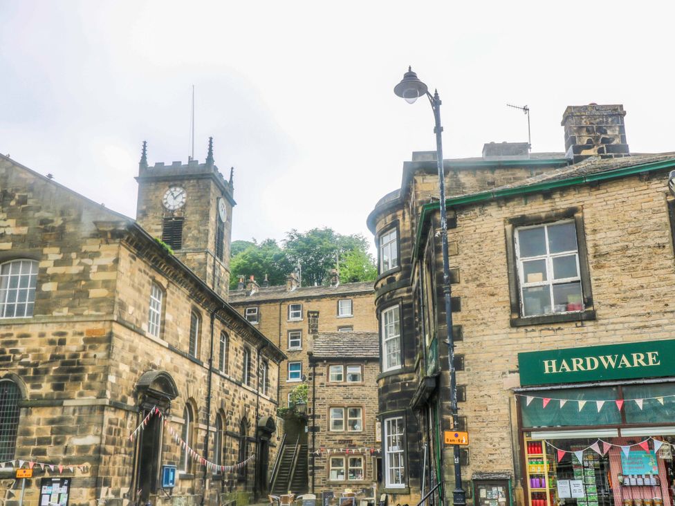 An outdoor area with a clock tower and a hardware store at Chapel House Annex in Scholes