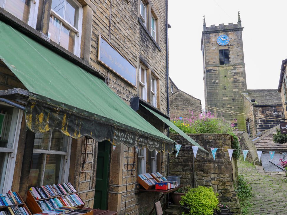 An outdoor view of a bookshop with a clock tower in the background at Chapel House Annex in Scholes