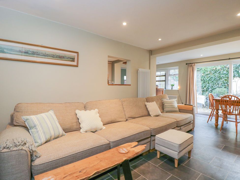 A living room with a sofa and dining area at Lavender Cottage in Bradford-on-Avon