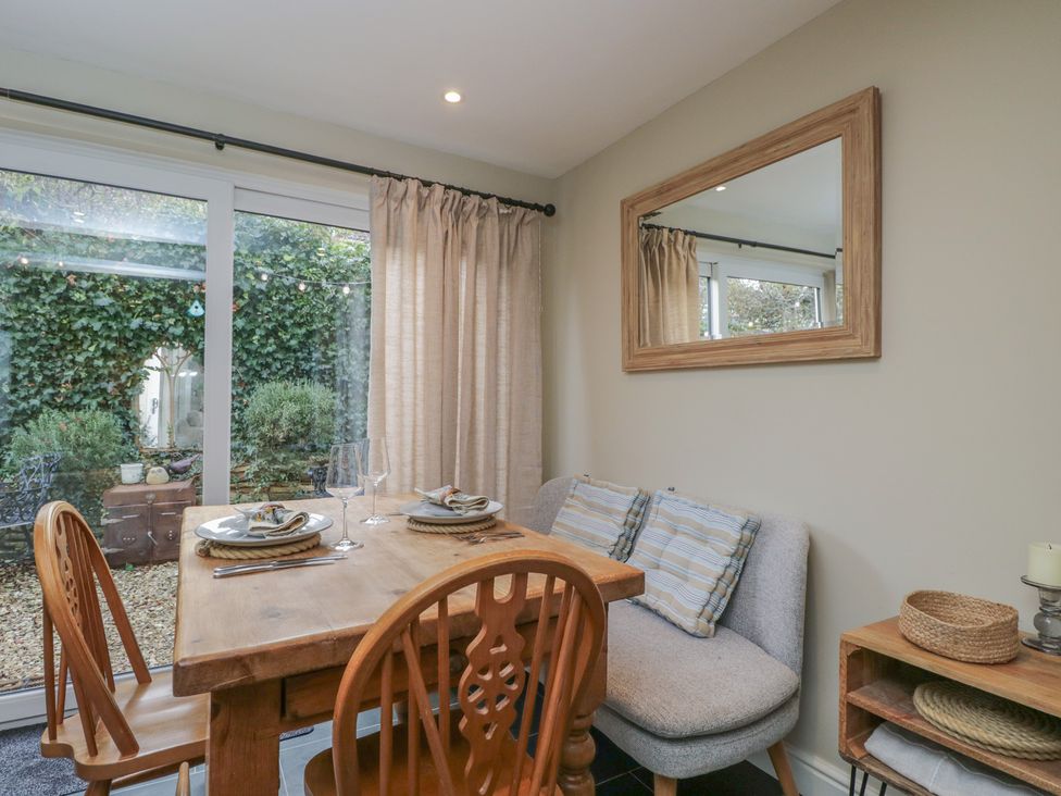 A dining area with a wooden table and chairs at Lavender Cottage in Bradford-on-Avon