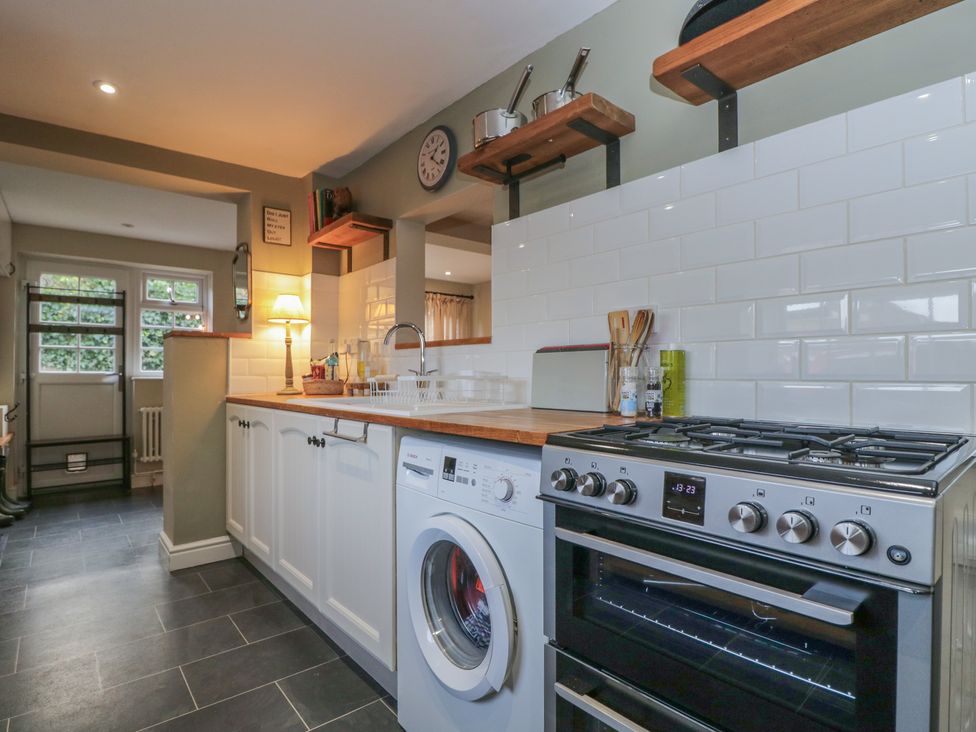 A kitchen with a washing machine and stove at Lavender Cottage in Bradford-on-Avon