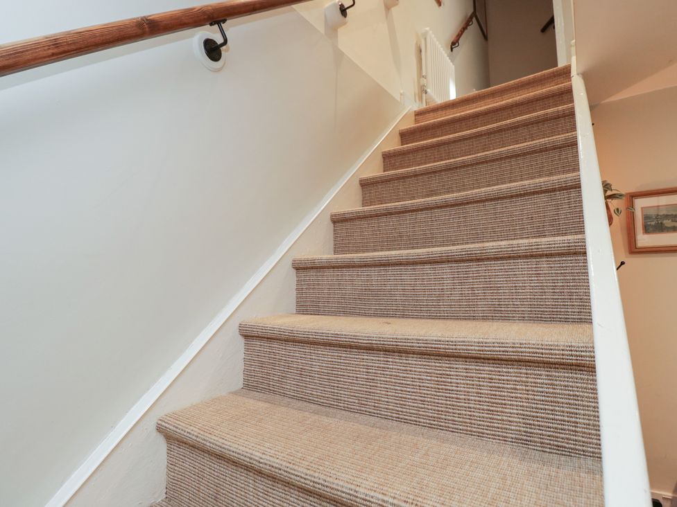 A staircase with carpet and a handrail at Lavender Cottage in Bradford-on-Avon