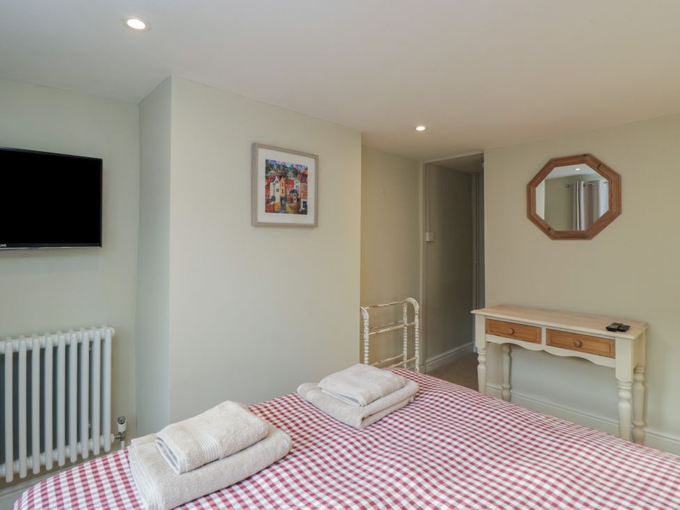 A bedroom with a bed and television at Lavender Cottage in Bradford-on-Avon