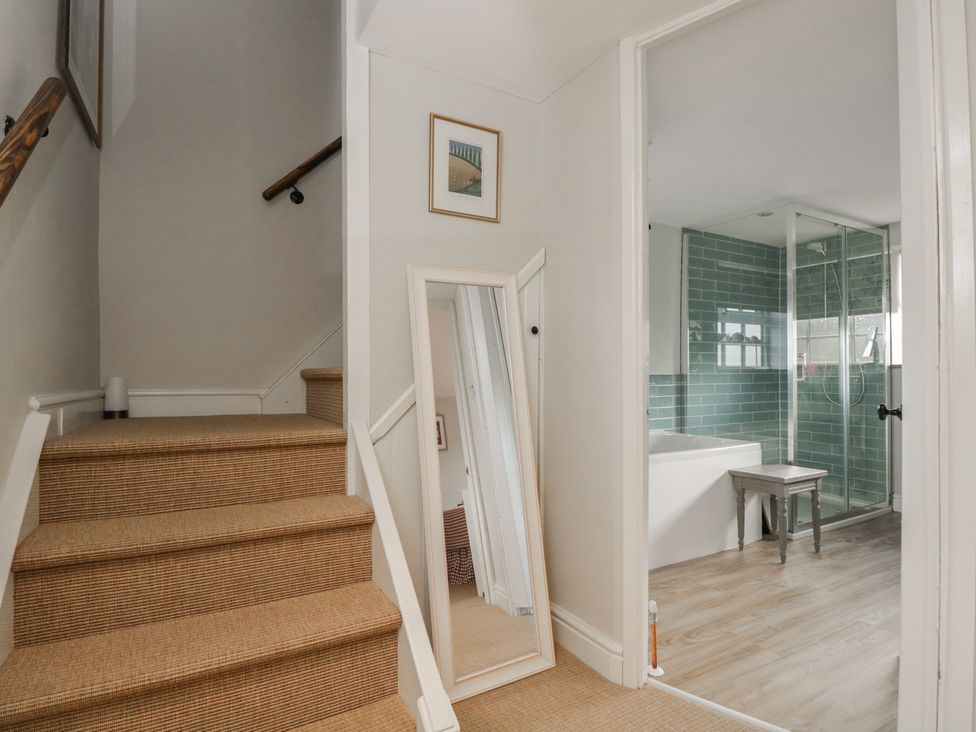 A hallway with stairs leading to a bathroom at Lavender Cottage in Bradford-on-Avon