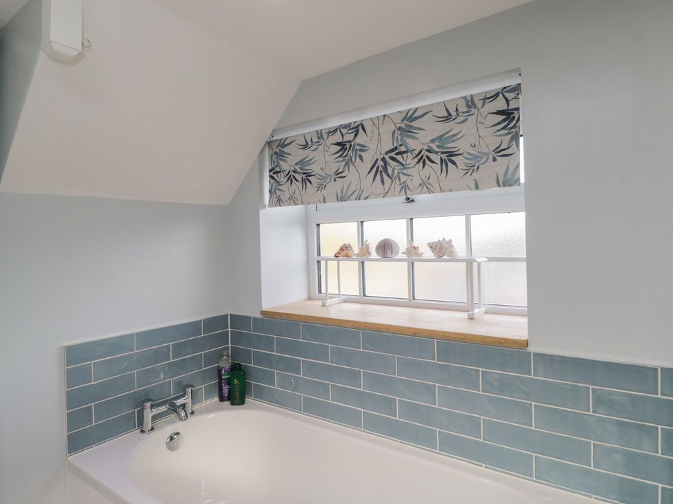 A bathroom with a bathtub and a window at Lavender Cottage Bradford-on-Avon