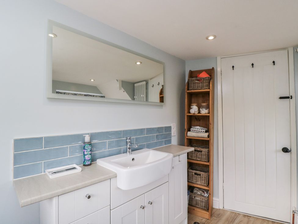A bathroom with a sink and mirror at Lavender Cottage in Bradford-on-Avon