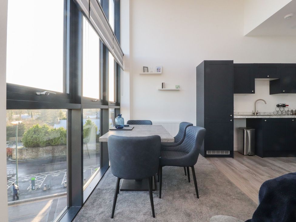 A dining room with a table and chairs at Apartment 20, River View in Preston