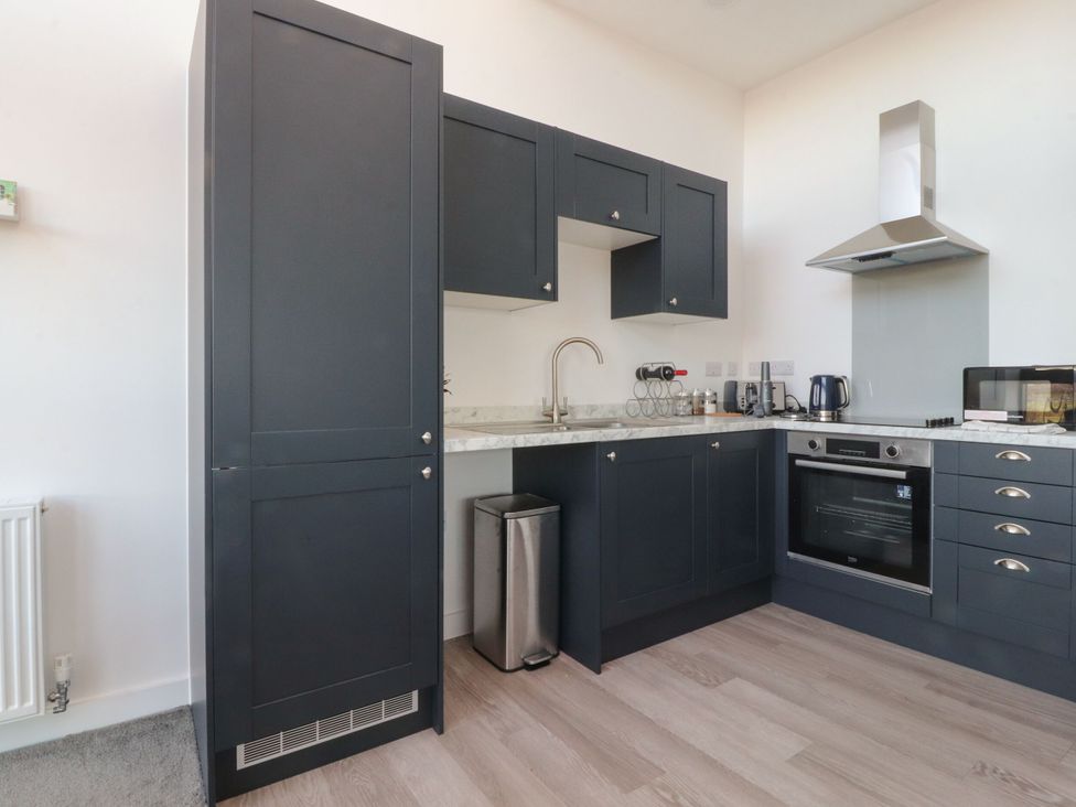 A kitchen with cabinets, sink, oven, and appliances at Apartment 20, River View in Preston