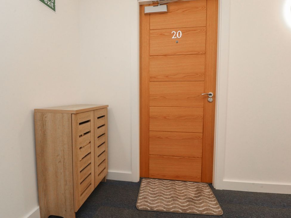 A hallway with a cabinet and door numbered 20 at Apartment 20, River View in Preston