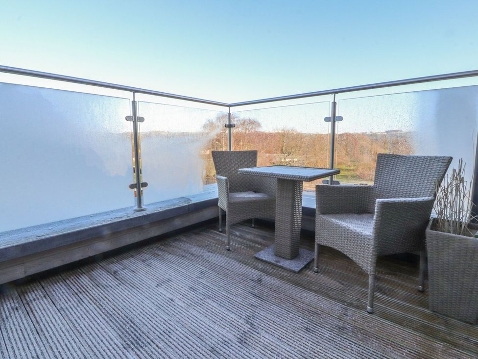 A balcony with a table and chairs at Apartment 20, River View in Preston
