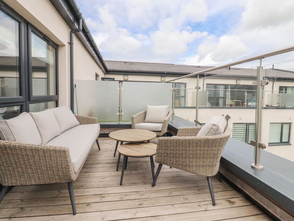 A balcony with a sofa and coffee table at Apartment 20, River View in Garstang