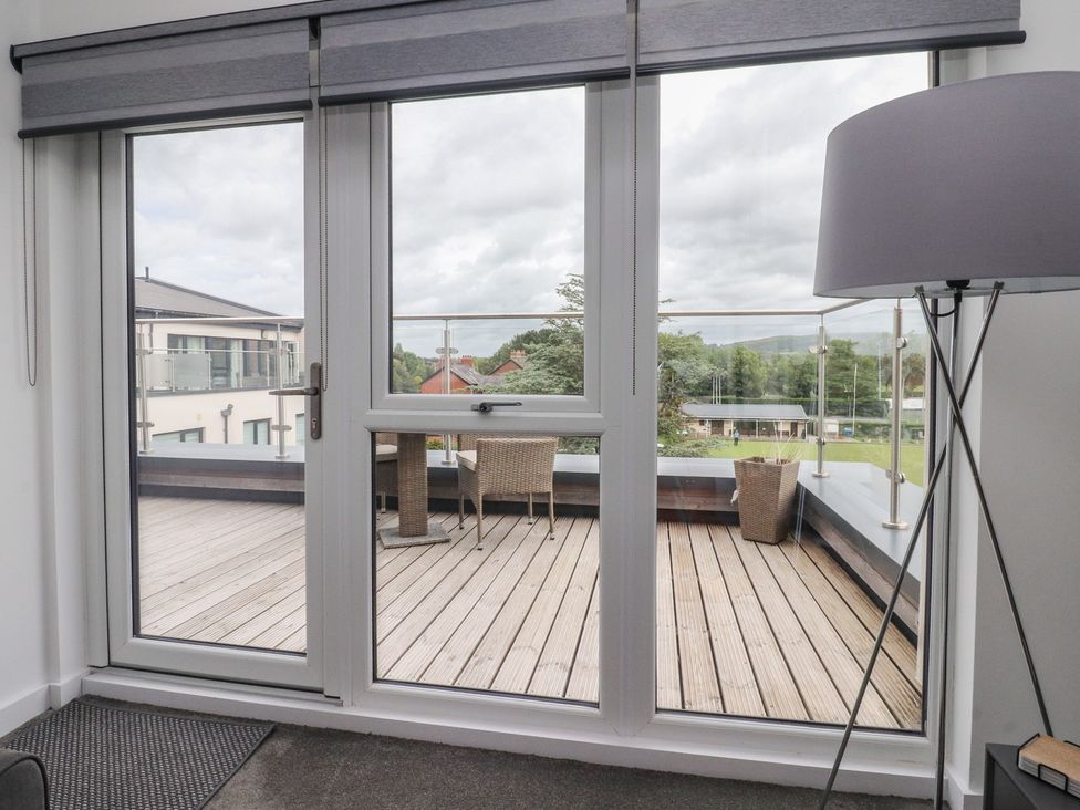 A living room with a sliding door to a deck at Apartment 20, River View in Garstang