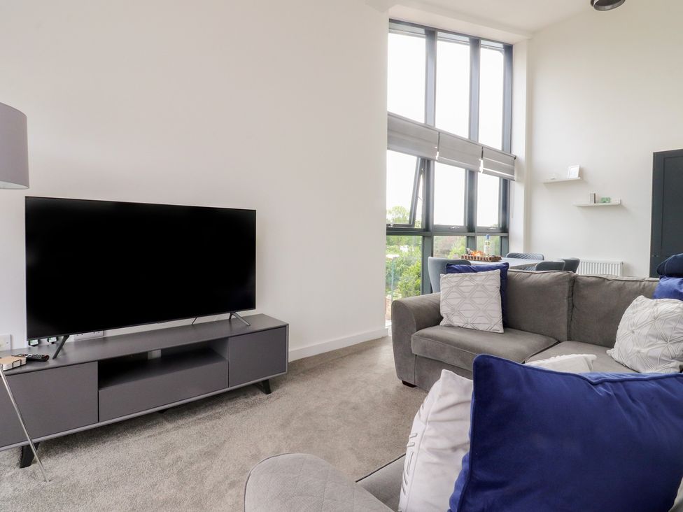 A living room with a television and sofa at Apartment 20, River View in Garstang