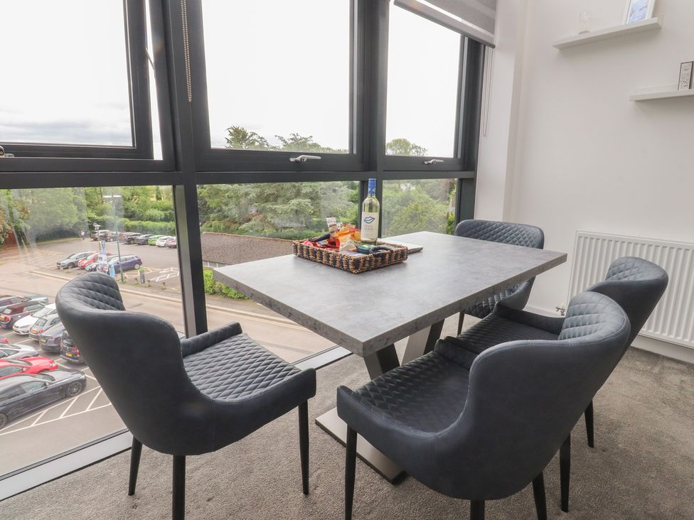 A dining room with a table and chairs at Apartment 20, River View in Garstang