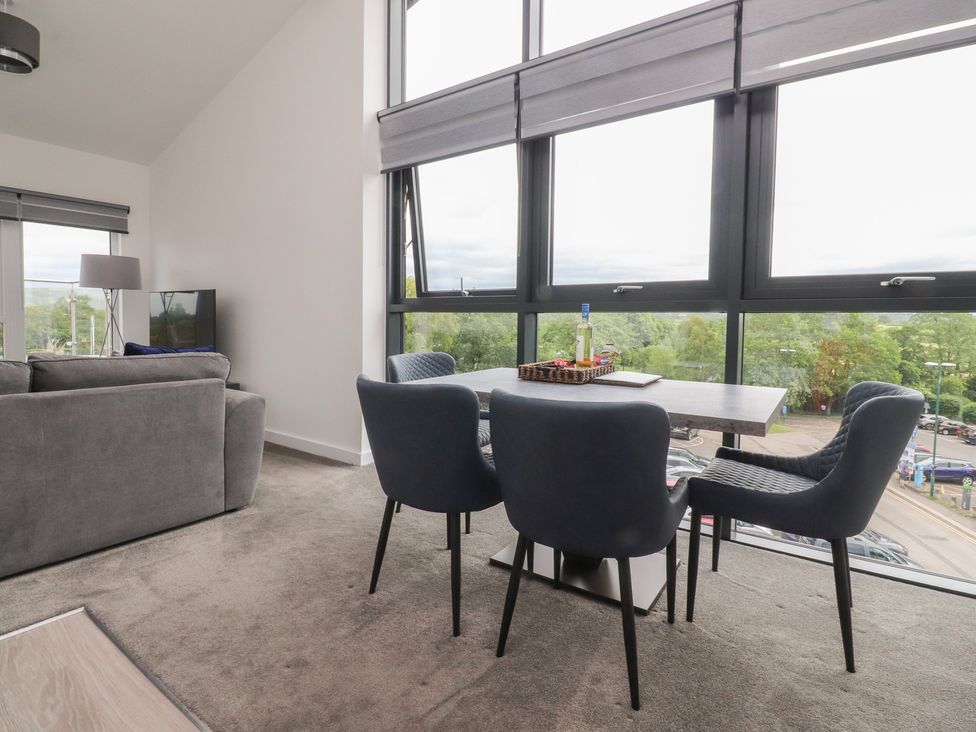 A living room with a sofa, table, and chairs at Apartment 20, River View, Garstang