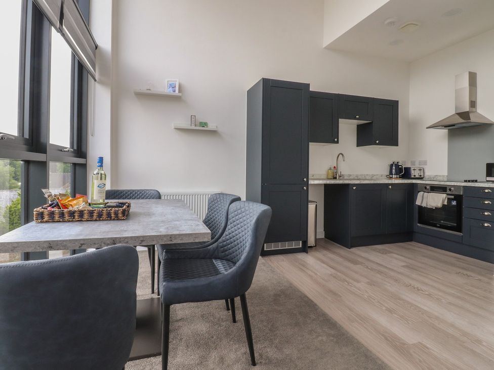 A kitchen with a table and chairs in Apartment 20, River View Garstang