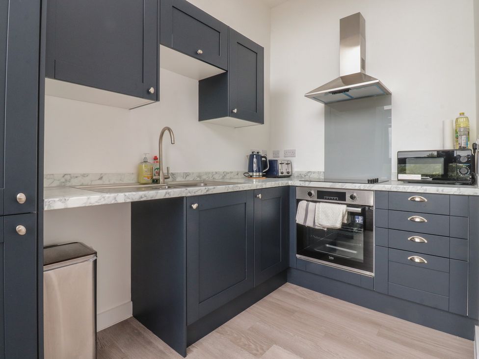 A kitchen with cabinets, sink and appliances at Apartment 20, River View in Garstang