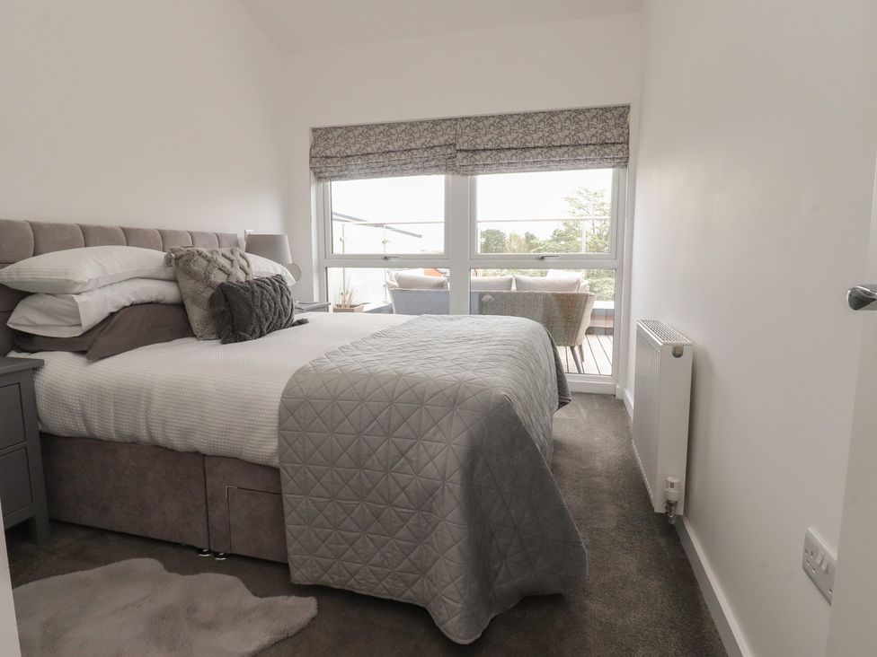 A bedroom with a bed and window at Apartment 20, River View Garstang