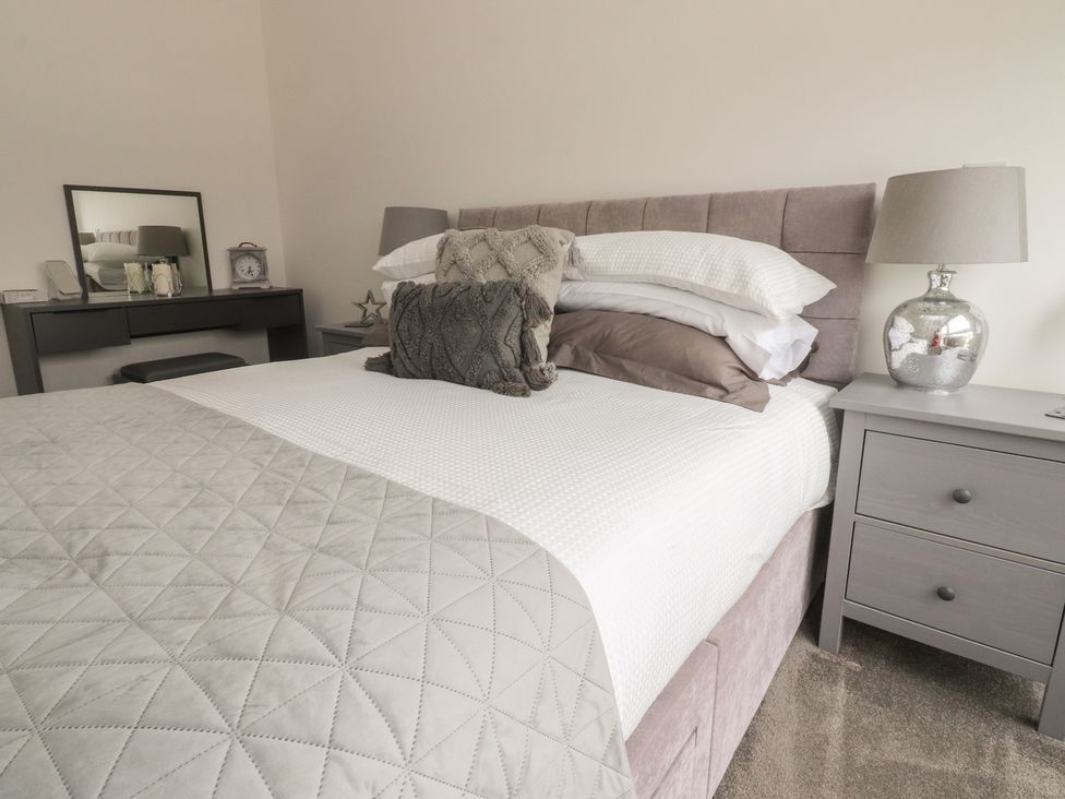 A bedroom with a bed and bedside table at Apartment 20, River View in Garstang