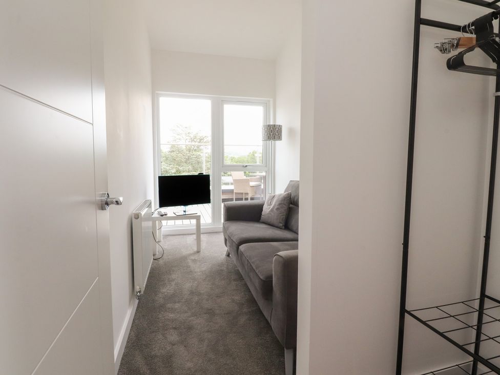 A living room with a sofa and TV at Apartment 20, River View in Garstang