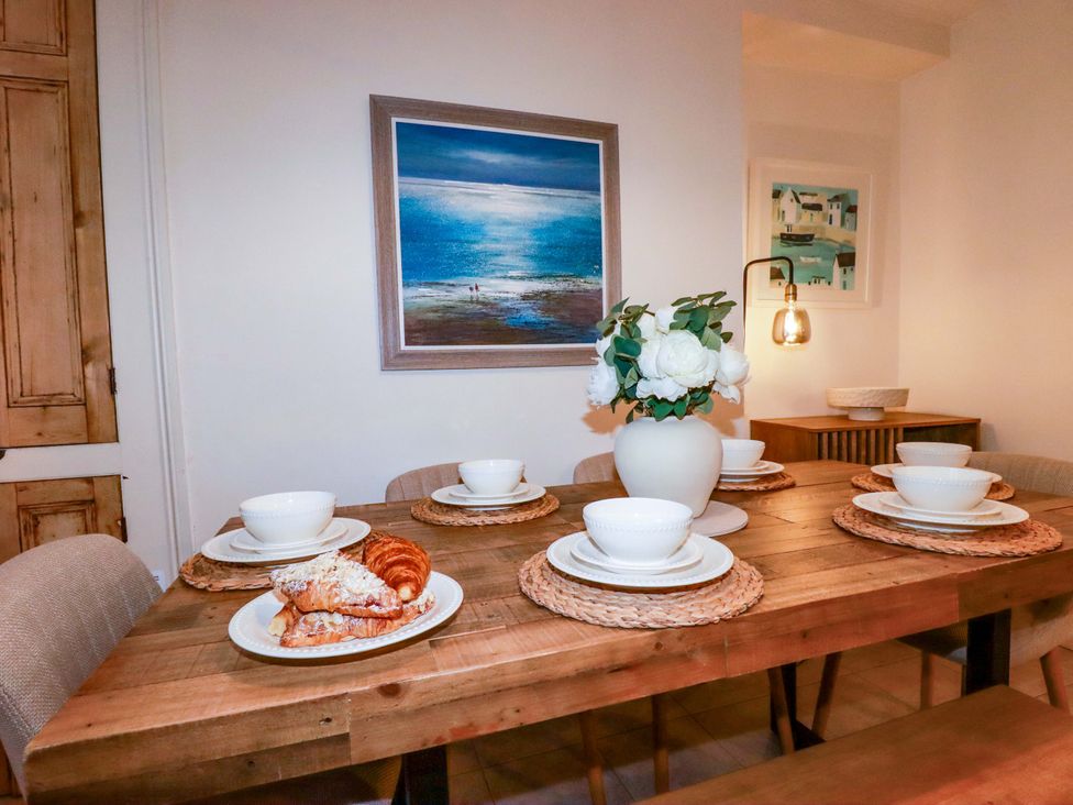 A dining room with a table set for breakfast at Chapel Cottage in Mevagissey