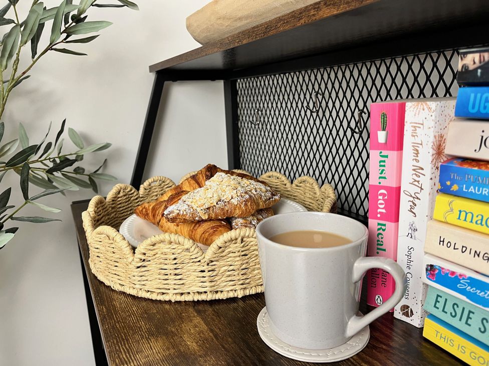 A kitchen with pastries and a cup of tea at Chapel Cottage Mevagissey