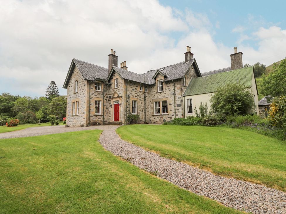 A house with a garden and pathway at Druidaig Lodge in Kyle
