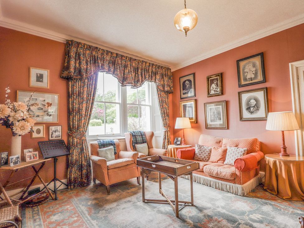 A living room with a sofa and armchair at Druidaig Lodge in Kyle