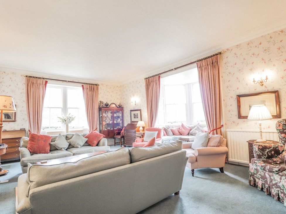A living room with sofa and chairs at Druidaig Lodge in Kyle