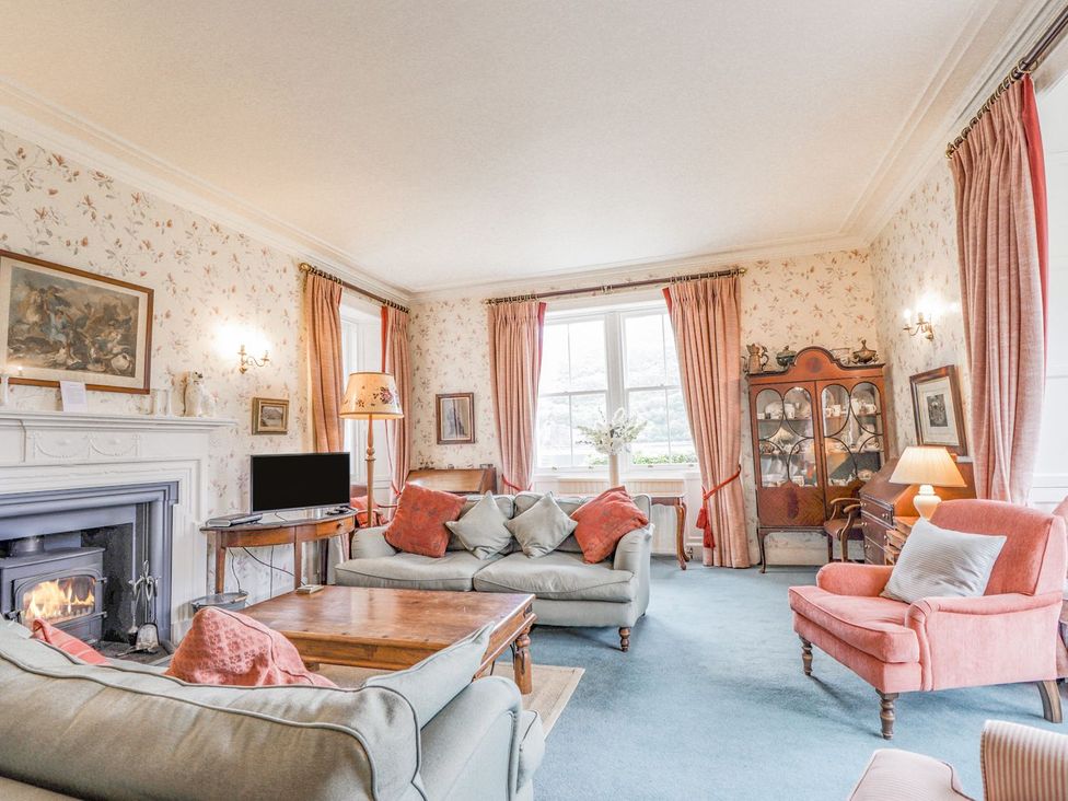 A living room with sofas and a coffee table at Druidaig Lodge in Kyle