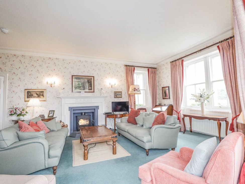 A living room with a fireplace and sofas at Druidaig Lodge in Kyle