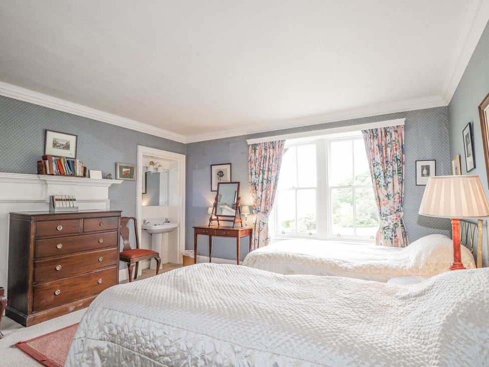 A bedroom with two beds and a dresser at Druidaig Lodge in Kyle