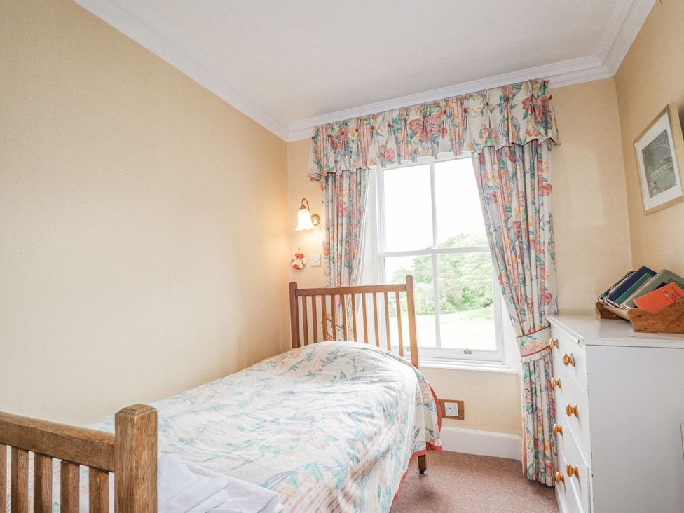 A bedroom with a bed and window at Druidaig Lodge in Kyle