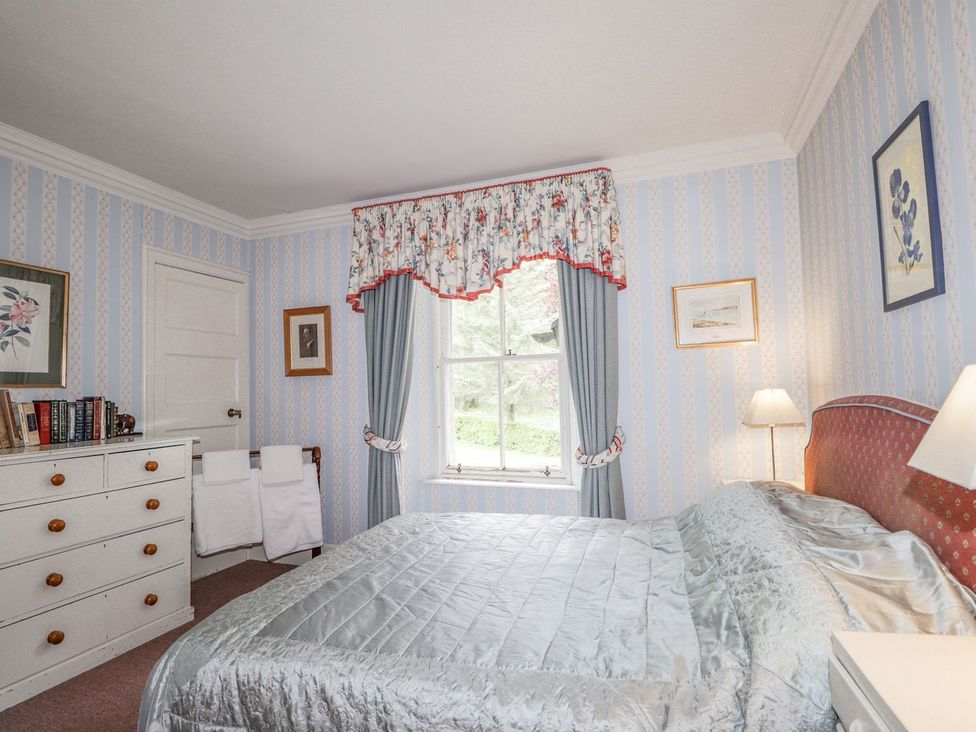 A bedroom with a bed and a window at Druidaig Lodge in Kyle