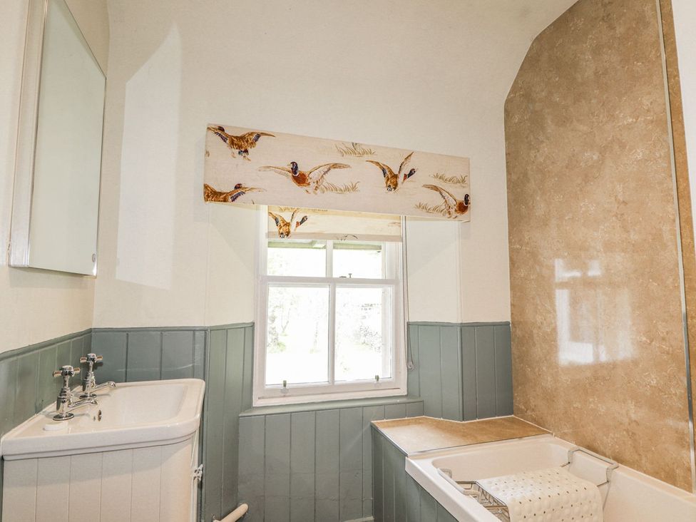 A bathroom with sink and window at Druidaig Lodge in Kyle