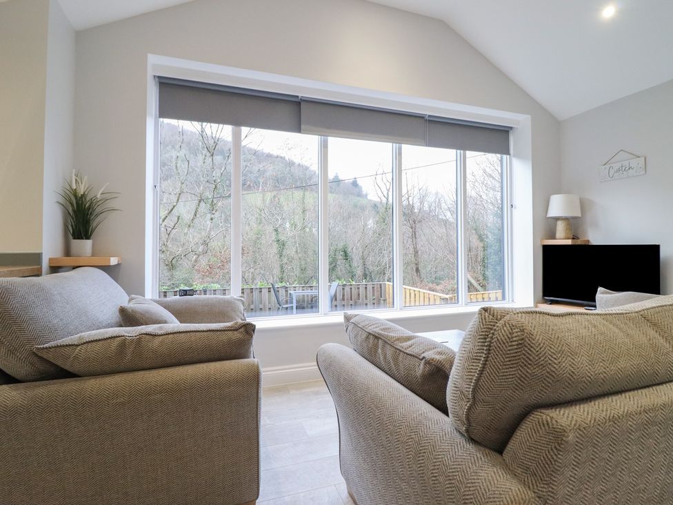 A living room with sofas and a television at Lodge at Nadur