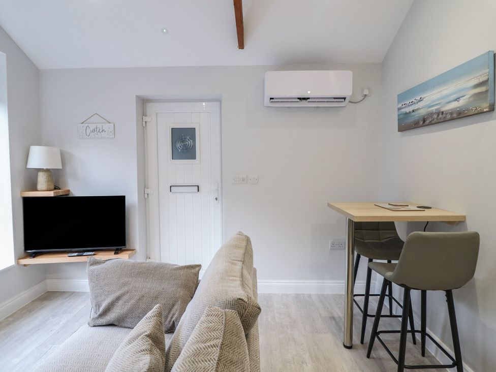A living room with a sofa and television at Lodge at Nadur