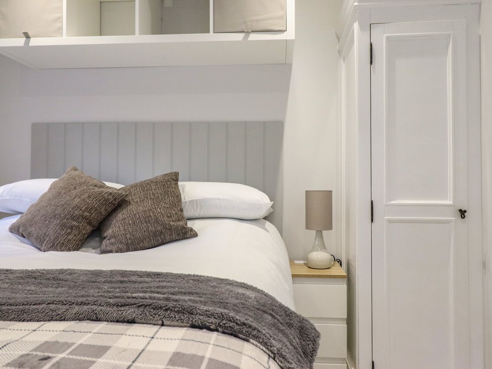A bedroom with a bed and bedside lamp at Lodge at Nadur