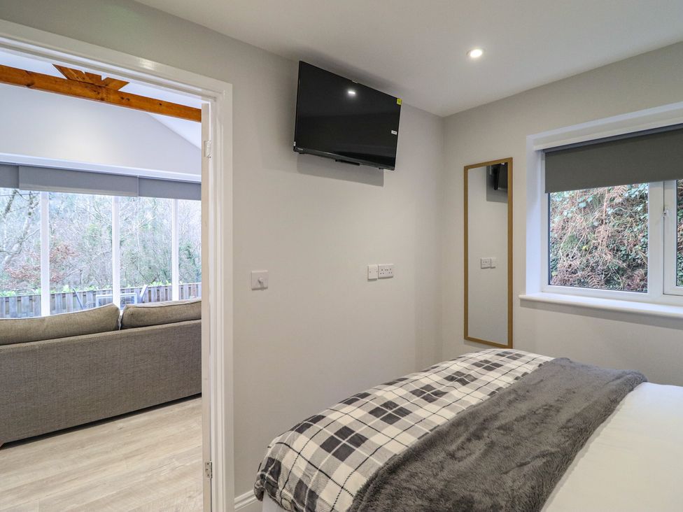 A bedroom with a bed and television at Lodge at Nadur
