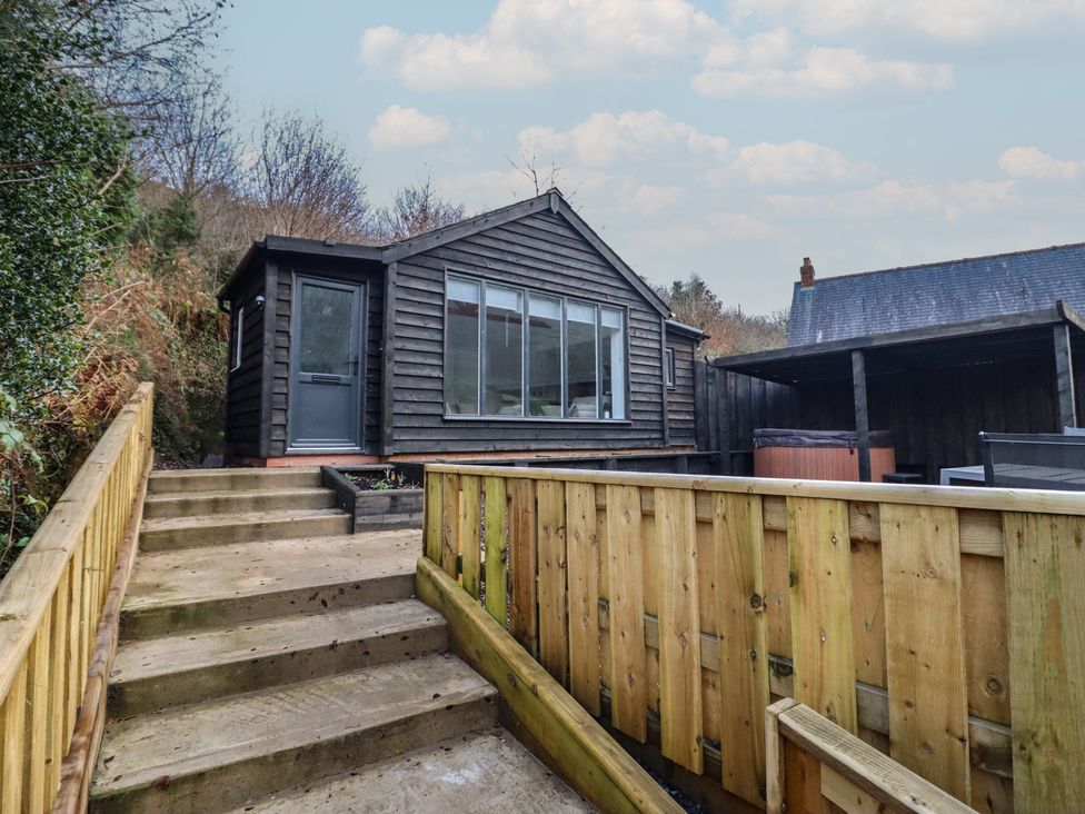 A house with large windows and a hot tub at Lodge at Nadur