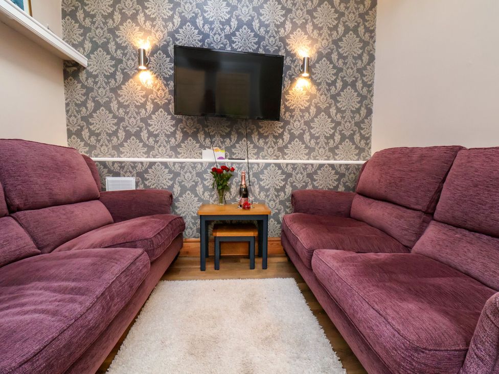 A living room with two sofas and a television at Sunnyvale House in Whitby