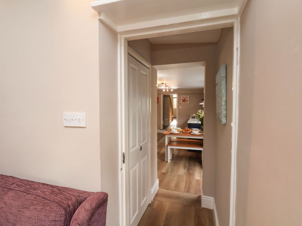 A hallway with a door leading to a dining area at Sunnyvale House in Whitby