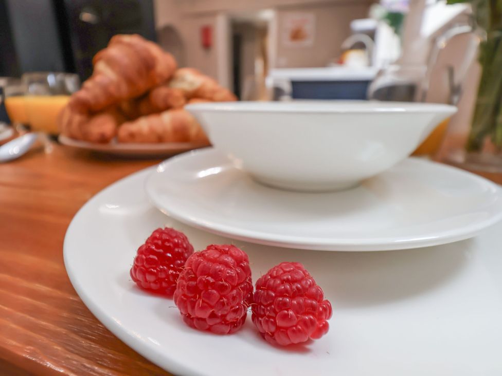 A plate with raspberries and a bowl at Sunnyvale House in Whitby