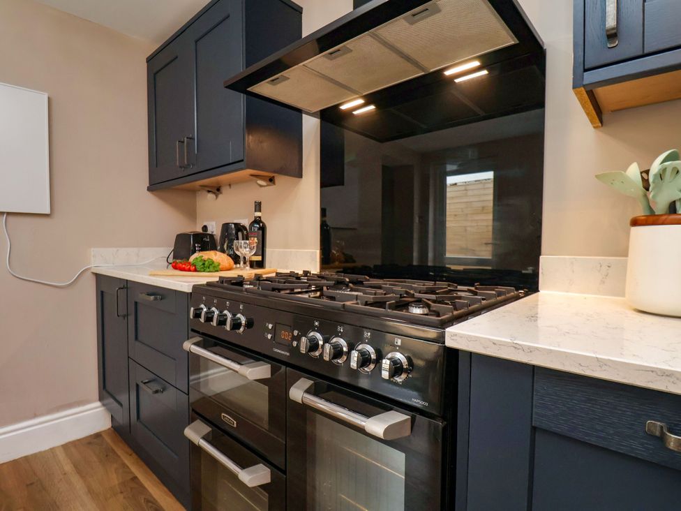 A kitchen with cabinets and a stove at Sunnyvale House in Whitby